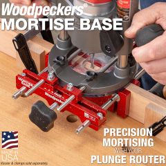 The Mortise Base straddling a thin, 3/4" table leg while being used to rout a precise 1/4" wide mortise. Scraps of wood are clamped to the workpiece to limit the length of the mortise.