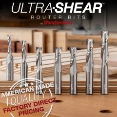 Ultra-Shear 1/2" Solid Carbide Spiral Bits in 7 sizes in foreground with sample of finished cuts in background. 