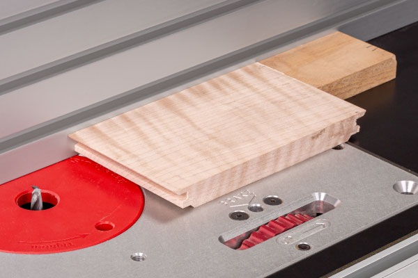 Waste block from lock miter cuts supports back of stock for dado cut.